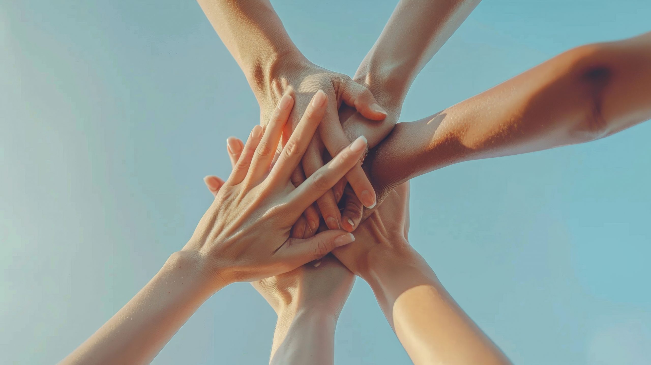 Group of People Putting Their Hands Together